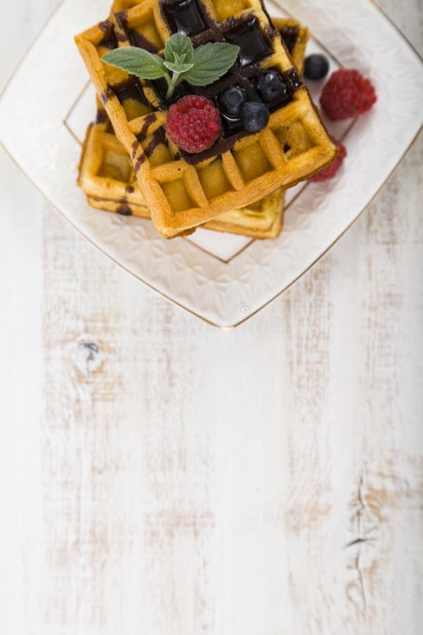 Belgian waffles with raspberries, blueberries and mint, covered