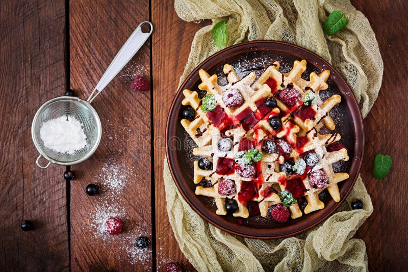 Belgium waffles with raspberries, chocolate and syrup stock photography Belgium waffles with raspberries, chocolate and syrup stock photography