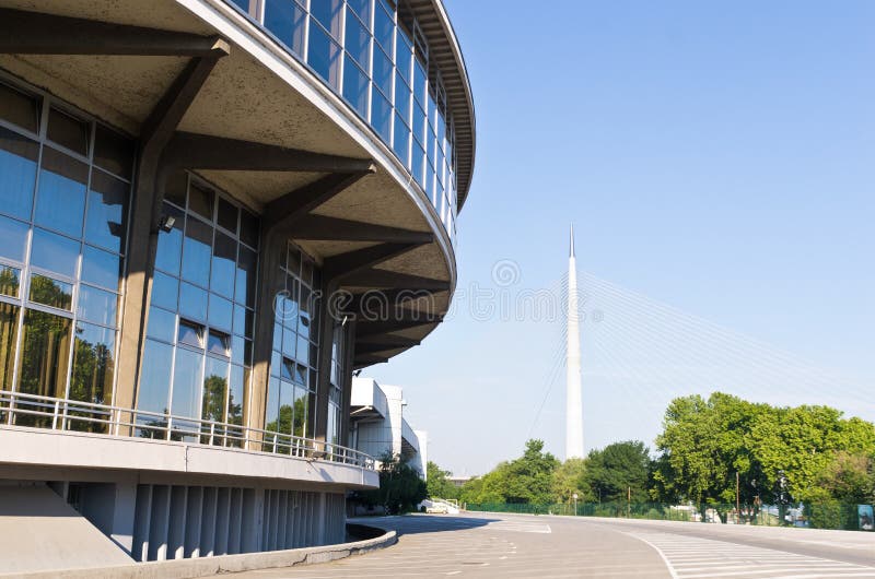 Belgrade fair glass building reflections with Ada bridge in background