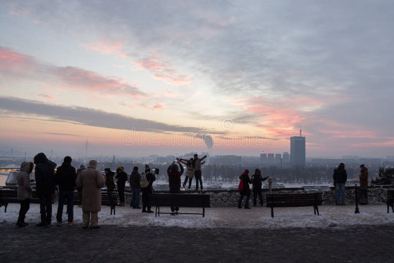 Silhouette of people taking photos with their smartphones and cameras of the New Belgrade panorama. Silhouette of people taking photos with their smartphones and cameras of the New Belgrade panorama