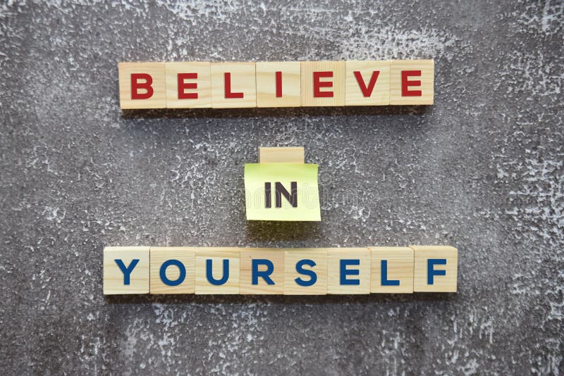 BELIEVE IN YOURSELF word on wooden blocks and sticky note lifestyle concept