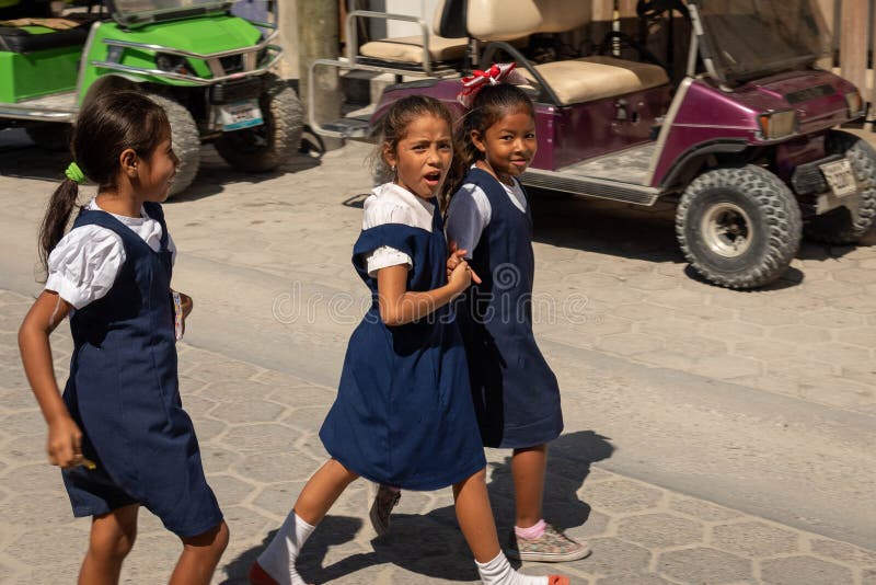 Belizean school aged girls crossing the street