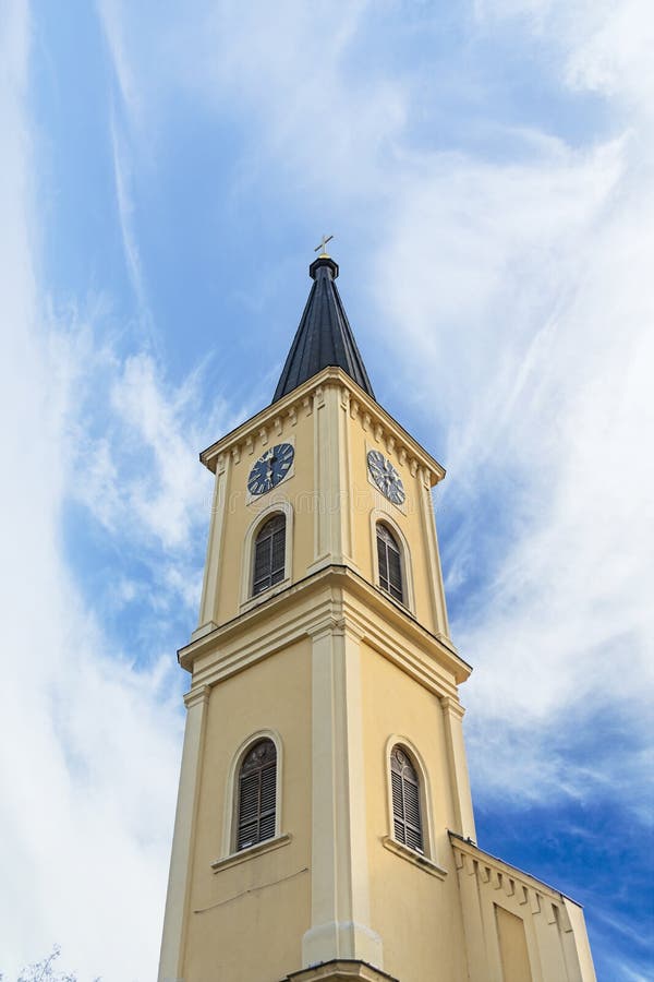 Bell tower with clock at Old town with cloudy sky