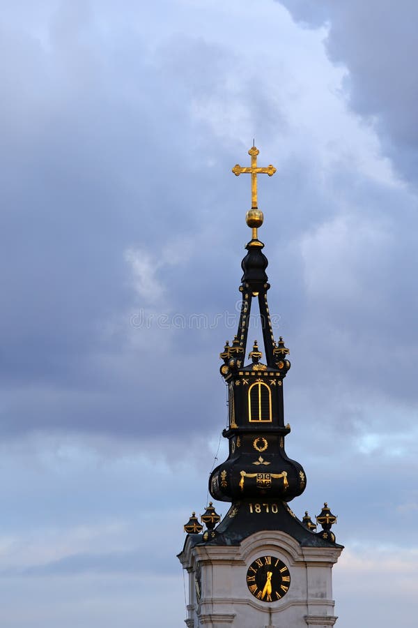 Bell tower of Saint Nicholas church in Zemun,Serbia. Bell tower of Saint Nicholas church with golden cross and cloudy sky royalty free stock photos Bell tower of Saint Nicholas church in Zemun,Serbia. Bell tower of Saint Nicholas church with golden cross and cloudy sky royalty free stock photos
