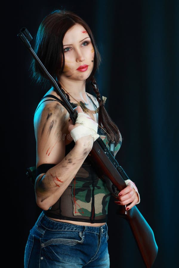 Bella donna che tiene un'arma immagine stock libera da diritti