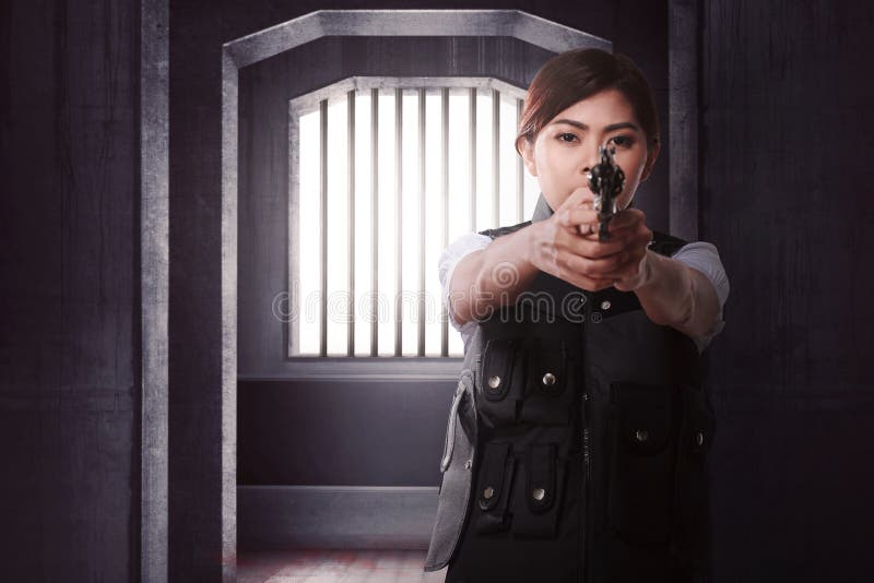 Bella donna asiatica con la pistola che sta da solo fotografie stock libere da diritti Bella donna asiatica con la pistola che sta da solo fotografie stock libere da diritti