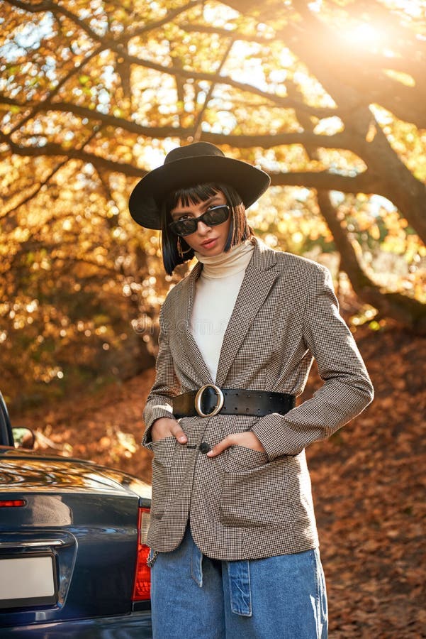 Bella giovane donna che posa vicino al cabriolet Stagione di autunno immagini stock Bella giovane donna che posa vicino al cabriolet Stagione di autunno immagini stock