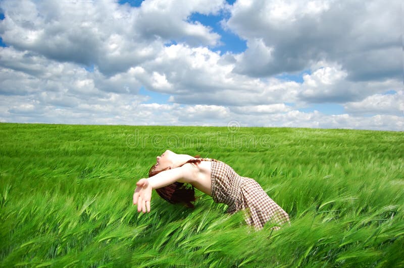 Beautiful young girl lying at green field, Photo #1. Beautiful young girl lying at green field, Photo #1