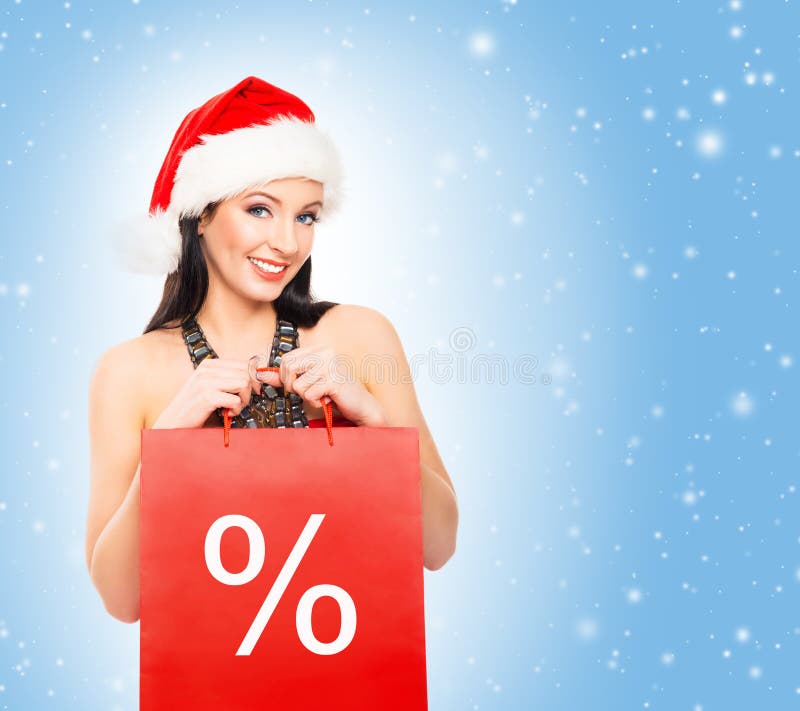 Bella ragazza del cliente di Natale su un fondo blu-chiaro fotografie stock Bella ragazza del cliente di Natale su un fondo blu-chiaro fotografie stock