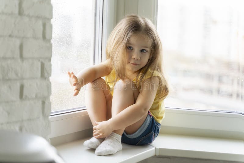 bella ragazzina guarda fuori dalla finestra sotto la pioggia casa di riposo immagini stock libere da diritti bella ragazzina guarda fuori dalla finestra sotto la pioggia casa di riposo immagini stock libere da diritti