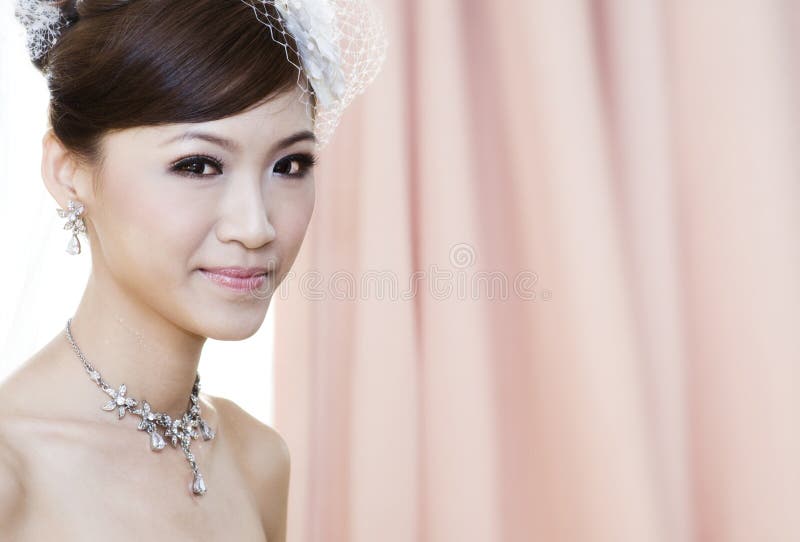 Beautiful Young Asian bride smiling. Beautiful Young Asian bride smiling