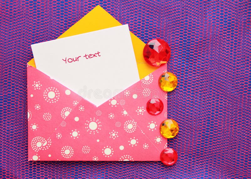 Pink envelope with white circles and a note, decorated with jewels of yellow and red color, on brightly violet background. Pink envelope with white circles and a note, decorated with jewels of yellow and red color, on brightly violet background