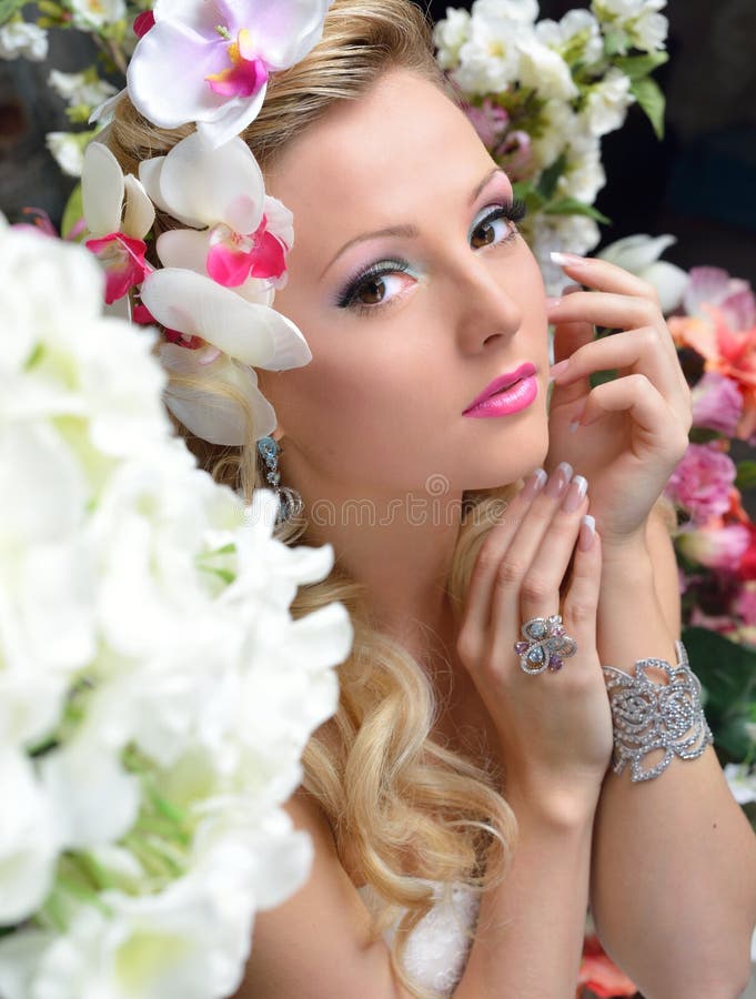 Belle femme chic autour des fleurs. photographie stock libre de droits Belle femme chic autour des fleurs. photographie stock libre de droits