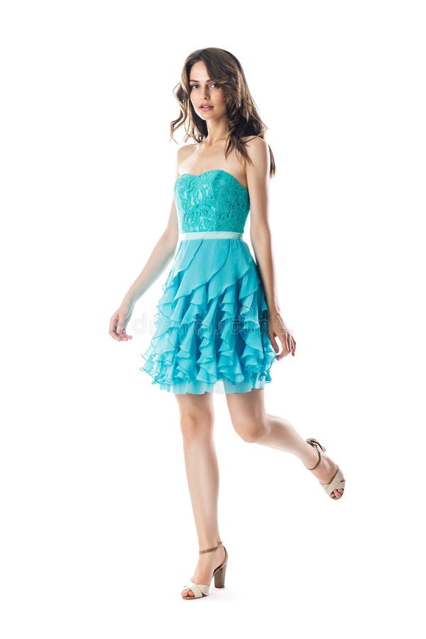Belle femme dans la robe de cocktail de turquoise dans le mouvement photos libres de droits Belle femme dans la robe de cocktail de turquoise dans le mouvement photos libres de droits