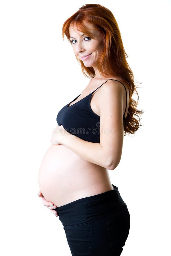 Belle femme enceinte détendant à la maison photographie stock Belle femme enceinte détendant à la maison photographie stock