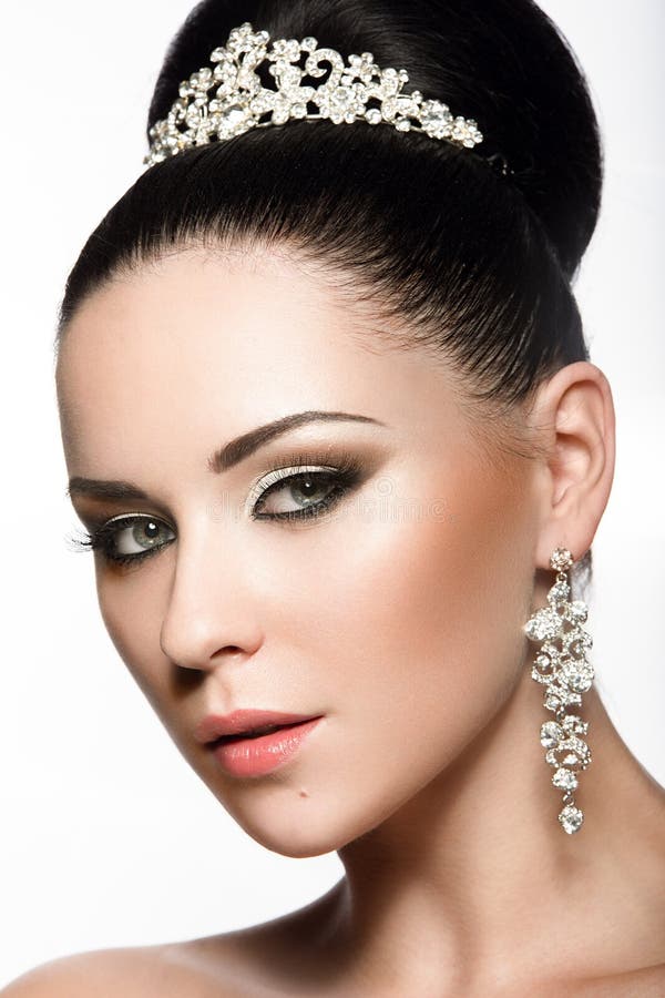 Belle fille aux cheveux foncés dans l'image d'une jeune mariée avec un diadème dans ses cheveux Visage de beauté images stock Belle fille aux cheveux foncés dans l'image d'une jeune mariée avec un diadème dans ses cheveux Visage de beauté images stock