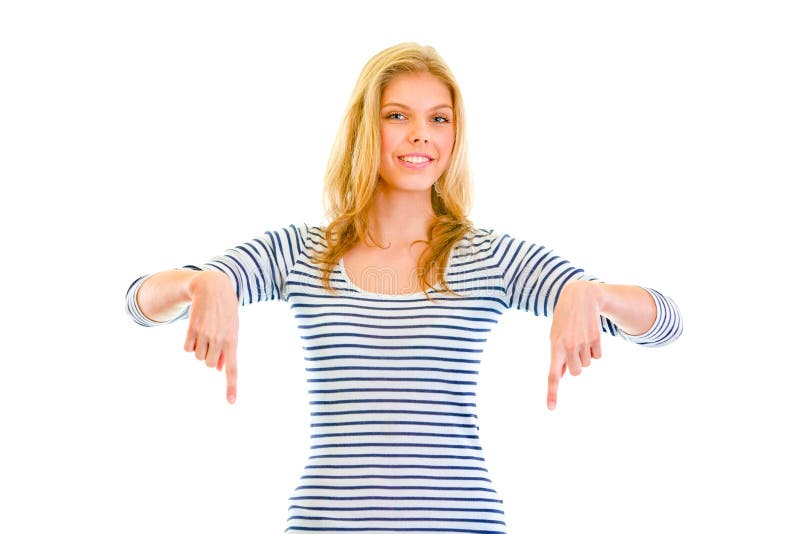 Belle fille de l'adolescence de sourire dirigeant des doigts vers le bas photographie stock libre de droits Belle fille de l'adolescence de sourire dirigeant des doigts vers le bas photographie stock libre de droits