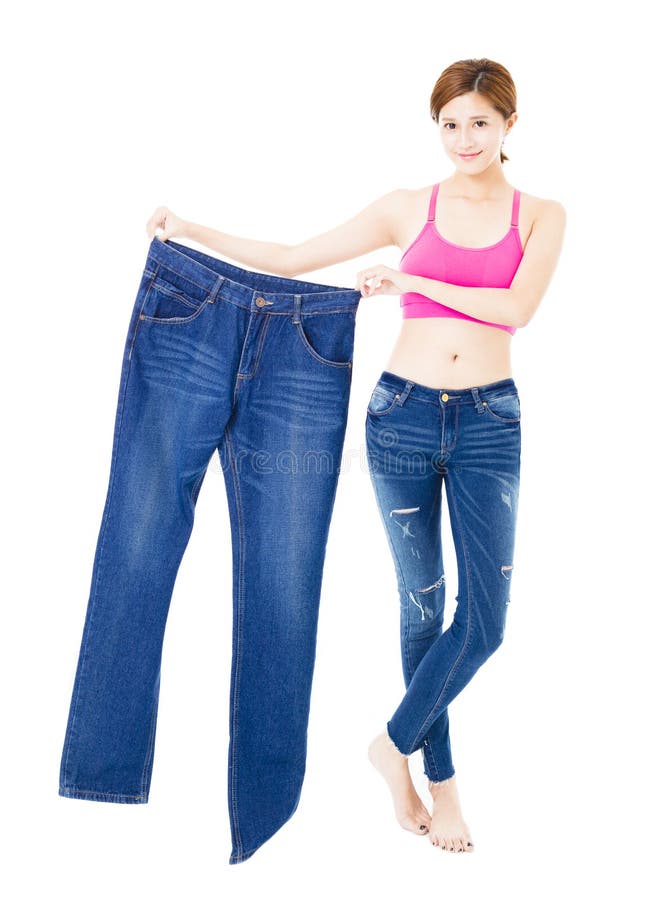 Belle jeune femme mince avec de grands jeans image stock