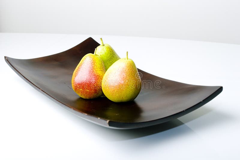 Beautiful delicious fresh pears in a modern style wooden vase. Beautiful delicious fresh pears in a modern style wooden vase