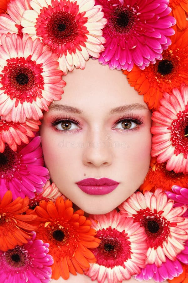 Portrait of beautiful woman with stylish make-up and bright flowers around her face. Portrait of beautiful woman with stylish make-up and bright flowers around her face
