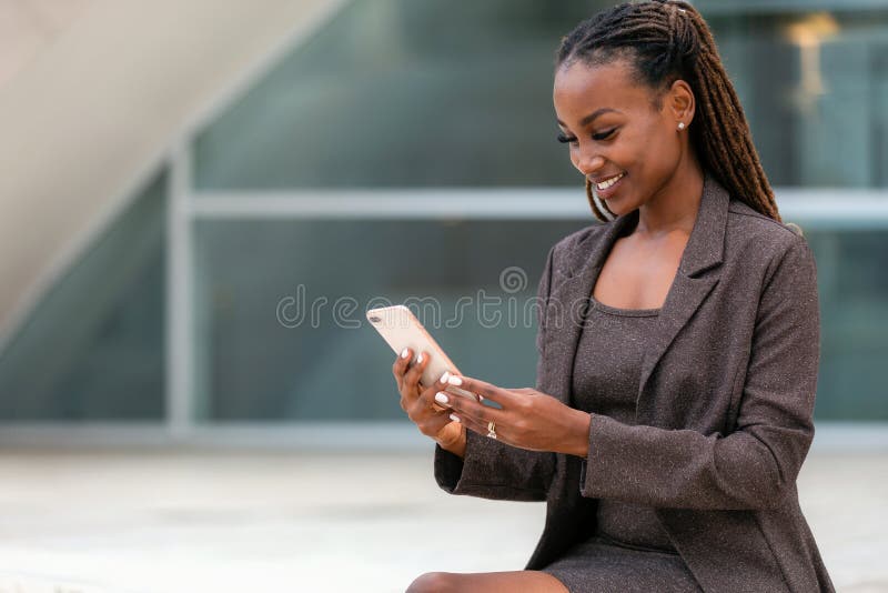 Beautiful african business woman at the office using smartphone technology, 5g, 4g, LTE, broadband internet, Advertisement commercial portrait for telecommunications, broadband, data, internet, smartphone, african american professional woman with cell phone. Beautiful african business woman at the office using smartphone technology, 5g, 4g, LTE, broadband internet, Advertisement commercial portrait for telecommunications, broadband, data, internet, smartphone, african american professional woman with cell phone