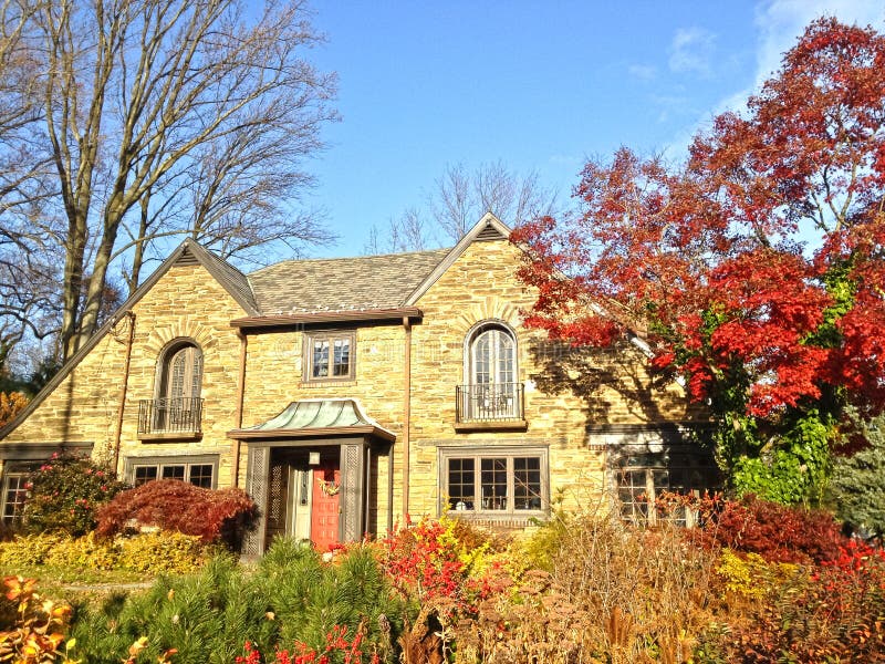 Upscale family house in Philadelphia suburbs. Front yard with trees and bushes in fall colors. Upscale family house in Philadelphia suburbs. Front yard with trees and bushes in fall colors.