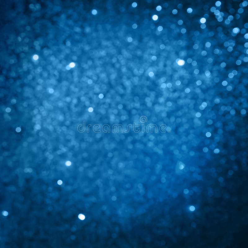 Blue beautiful blurred bokeh background with copy space. Christmas background. Glitter light spots on navy blue background, defocused. Blue beautiful blurred bokeh background with copy space. Christmas background. Glitter light spots on navy blue background, defocused
