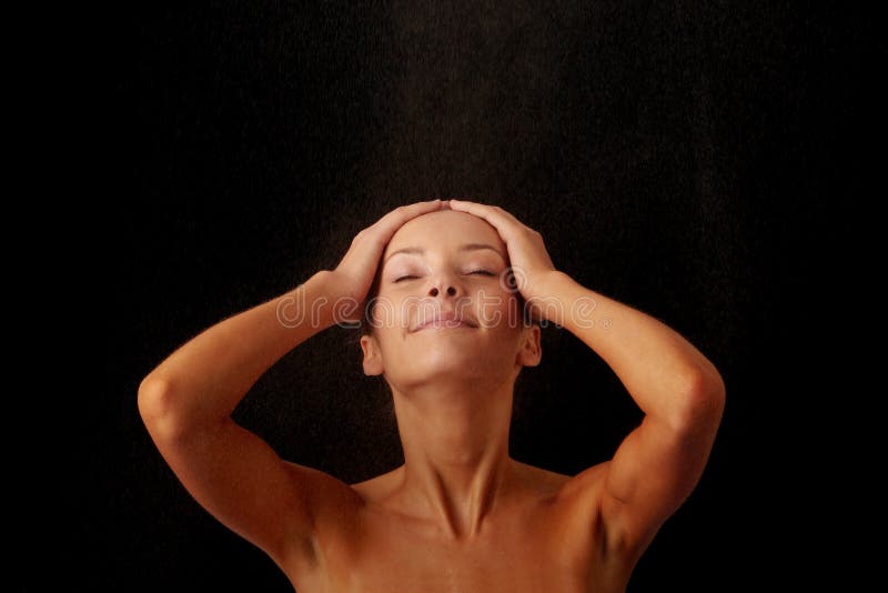 Close-up of beautiful happy wet woman face with water drop. Isolated on black background. Close-up of beautiful happy wet woman face with water drop. Isolated on black background