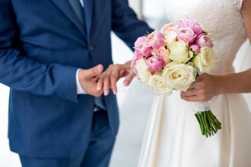 Bello mazzo nuziale delicato delle rose e dei fiori bianchi e rosa in mani della sposa immagini stock Bello mazzo nuziale delicato delle rose e dei fiori bianchi e rosa in mani della sposa immagini stock