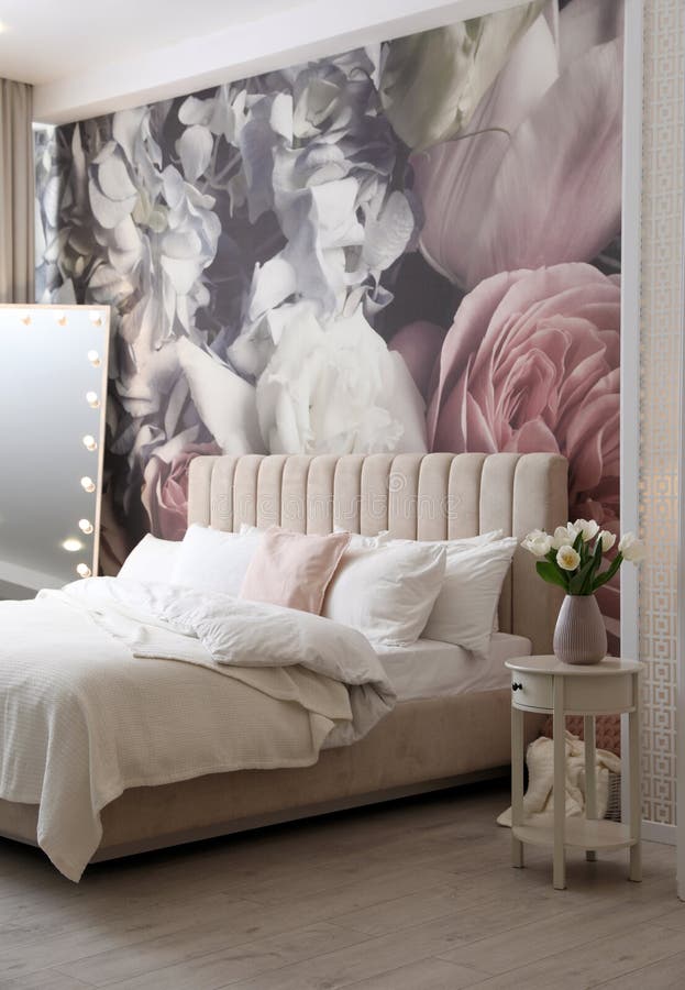 Belo interior de quarto com espelho-cama e padrão floral na parede fotos de stock royalty free