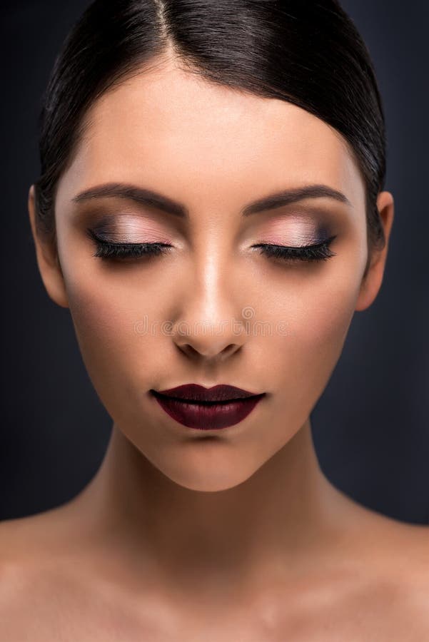 Beautiful young fashion model with bright makeup. Colored eyes and dark violet lips make-up.  Long false eyelashes. Professional style. Beautiful young fashion model with bright makeup. Colored eyes and dark violet lips make-up.  Long false eyelashes. Professional style