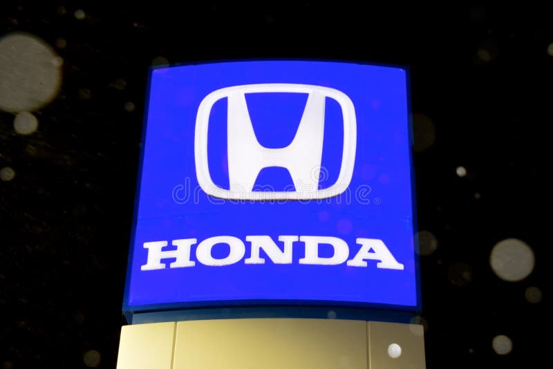 Snow is falling on the Honda Logo sign royalty free stock photos Snow is falling on the Honda Logo sign royalty free stock photos