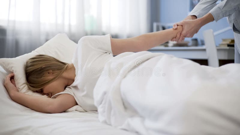 Mother pulling daughter hand trying to wake her up, late to school, problem kid, stock photo. Mother pulling daughter hand trying to wake her up, late to school, problem kid, stock photo