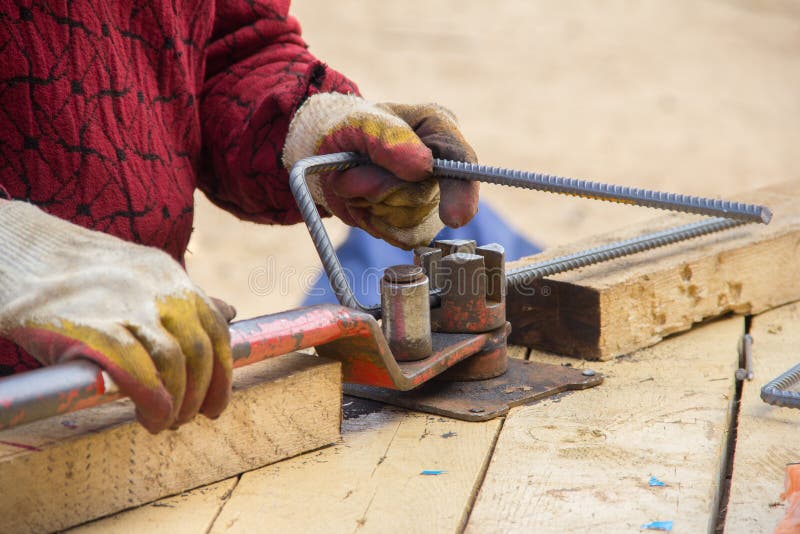 Bending Reinforcement Metal Rebar. Worker Using Bending Rebar Machine