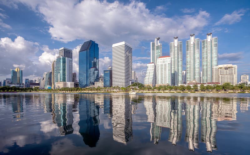 Cityscape of Tower, condomenium and bulding at benjakiti park with blue sky and river in Bangkok city, Thailand