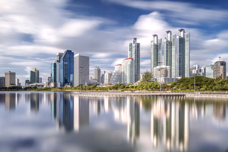 Cityscape of Tower, condomenium and bulding at benjakiti park with blue sky and river in Bangkok city, Thailand