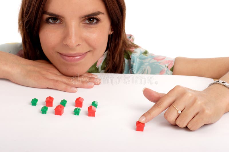 Pretty young woman playing with toy houses, real estate. Pretty young woman playing with toy houses, real estate