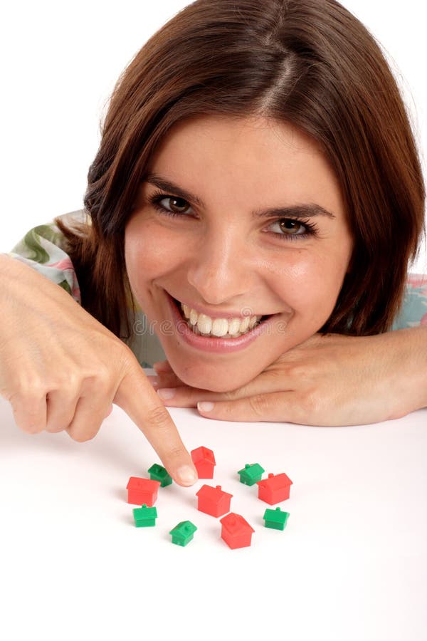 Pretty young woman playing with toy houses, real estate. Pretty young woman playing with toy houses, real estate