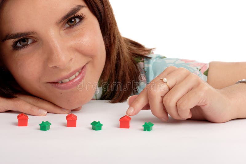 Pretty young woman playing with toy houses, real estate. Pretty young woman playing with toy houses, real estate