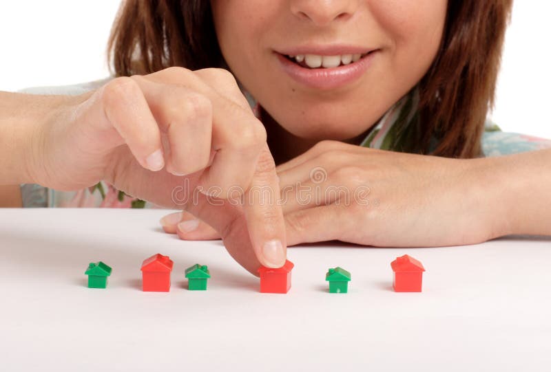 Pretty young woman playing with toy houses, real estate. Pretty young woman playing with toy houses, real estate