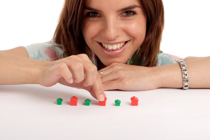 Pretty young woman playing with toy houses, real estate. Pretty young woman playing with toy houses, real estate