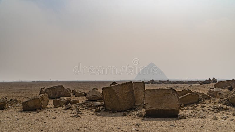 The Bent Pyramid is an ancient Egyptian pyramid located at the royal necropolis of Dahshur, approximately 40 kilometres south of royalty free stock photo