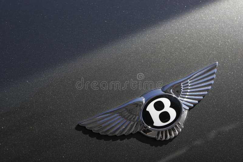 Bentley Motors logo on green sport car. Bentley badge. Bentley Motors logo on green sport car. Bentley badge.