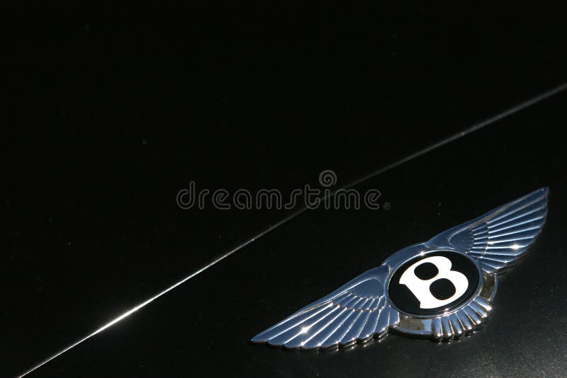 Bentley Motors logo on dark green sport car. Bentley badge. Bentley Motors logo on dark green sport car. Bentley badge.