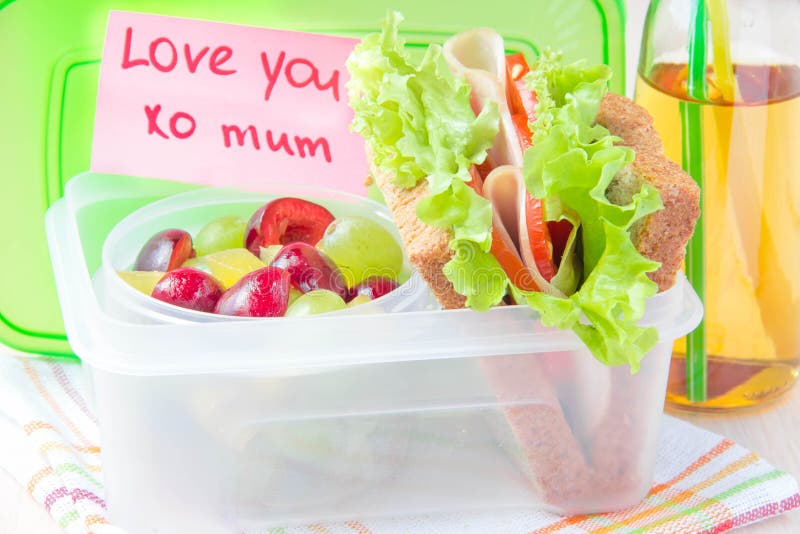 Bento lunch for your child in school, box with a healthy sandwich and fruit salad and apple juice in the bottle. For drinking royalty free stock photos Bento lunch for your child in school, box with a healthy sandwich and fruit salad and apple juice in the bottle. For drinking royalty free stock photos