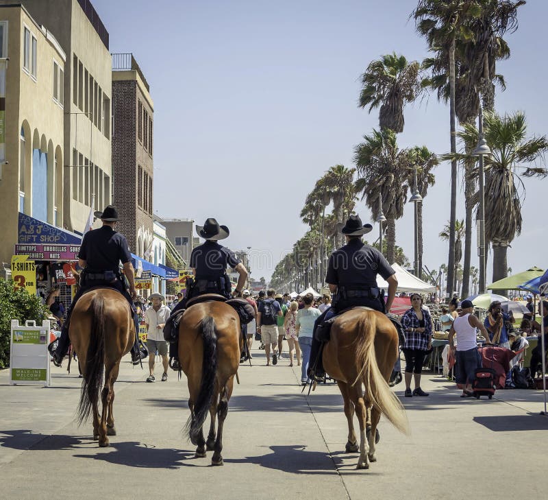 4 September 2016 - Los Angeles, USA. Three mounted police units patrolling at Venice Beach, full of tourists. 4 September 2016 - Los Angeles, USA. Three mounted police units patrolling at Venice Beach, full of tourists.