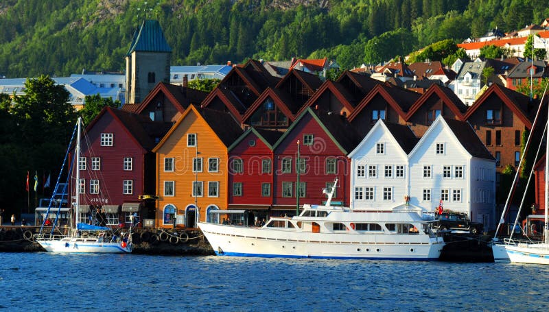 Boats lining the docks with colourful houses in Bergen, Norway, a UNESCO architectural heritage site. Boats lining the docks with colourful houses in Bergen, Norway, a UNESCO architectural heritage site.
