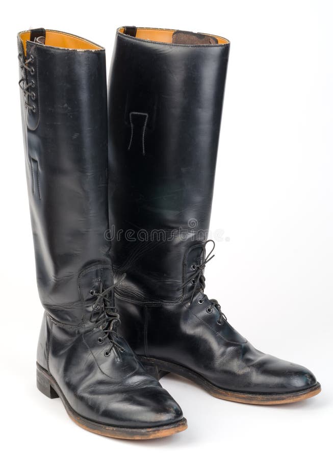Well worn, black, equestrian or mounted/motorcycle Police, riding boots isolated on white. Well worn, black, equestrian or mounted/motorcycle Police, riding boots isolated on white.