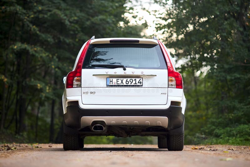 Berlin, Germany - October 3, 2023: Volvo XC90 4.4 v8 1st generation restyling 4WD SUV test drive in spring country road on forest background, back view. Berlin, Germany - October 3, 2023: Volvo XC90 4.4 v8 1st generation restyling 4WD SUV test drive in spring country road on forest background, back view