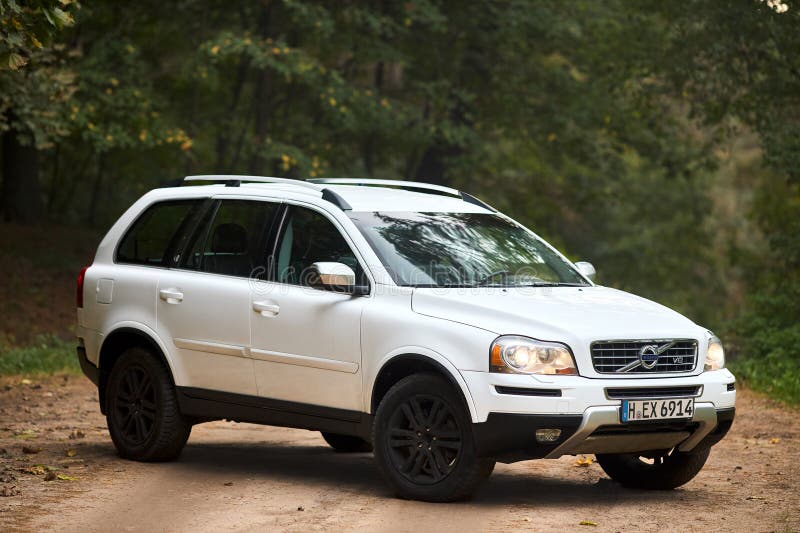 Berlin, Germany - October 3, 2023: Volvo XC90 4.4 v8 1st generation restyling 4WD SUV test drive in fall country road on forest background three quarter, right side front view. Berlin, Germany - October 3, 2023: Volvo XC90 4.4 v8 1st generation restyling 4WD SUV test drive in fall country road on forest background three quarter, right side front view